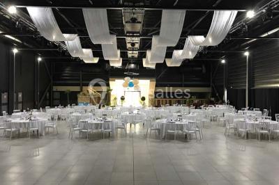 Salle de bain lumineuse avec lavabo sur meuble en bois, miroir mural, rideau jaune et fenêtre donnant sur l'extérieur.