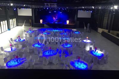 Maison moderne à deux étages avec façade en bois, terrasse et jardinières fleuries sur une allée pavée.