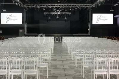 Maison moderne à deux étages avec façade en bois, terrasse et jardinières fleuries sur une allée pavée.