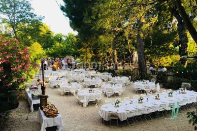 Plan de table sur un chevalet près de l'entrée d'une salle éclairée par des guirlandes lumineuses, ambiance festive.