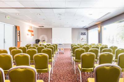 Salle de sport lumineuse avec tapis de course, vélos d'appartement et équipements de musculation.