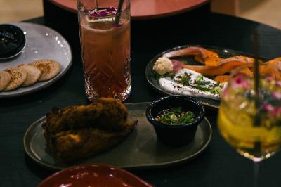 Chalet en bois éclairé de nuit avec balcons, toit enneigé et enseigne ’La Tapiaz’.