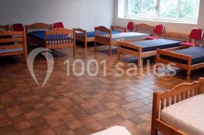 Évier double en inox avec robinet flexible, lave-vaisselle professionnel et sol en carrelage beige dans une cuisine.