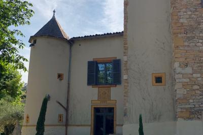 Parking extérieur de nuit, éclairé par des lumières jaunes et entouré d'arbres et de bâtiments.
