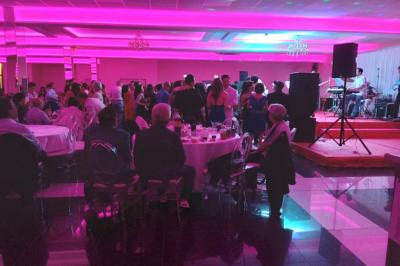 Cuisine professionnelle équipée avec lave-vaisselle industriel, réfrigérateur, plan de travail et cuisinière en inox.