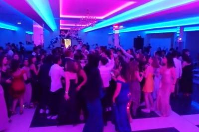 Cuisine professionnelle équipée avec lave-vaisselle industriel, réfrigérateur, plan de travail et cuisinière en inox.