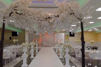 Cuisine professionnelle équipée avec lave-vaisselle industriel, réfrigérateur, plan de travail et cuisinière en inox.