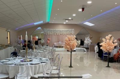 Cuisine professionnelle équipée avec lave-vaisselle industriel, réfrigérateur, plan de travail et cuisinière en inox.