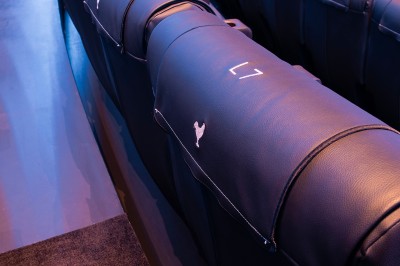 Vue intérieure d'un hall lumineux avec des stands colorés, des escaliers roulants et de grandes baies vitrées.