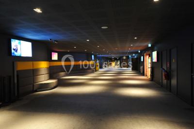 Hall d'entrée d'un cinéma Pathé avec un comptoir d'accueil, des sièges et un décor moderne.