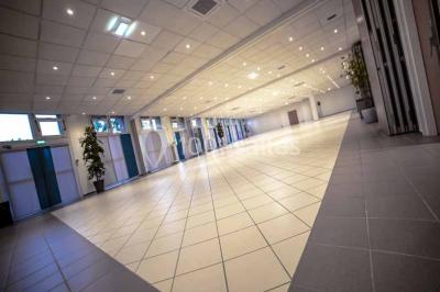 Miniature Salle du RDC Entrée d'un bâtiment avec escalier central, écrans d'affichage, plantes décoratives et sol en parquet.