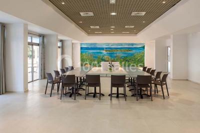 Deux tasses blanches avec cuillères sur un plateau, posées sur une table près d'une lampe dans une chambre lumineuse.