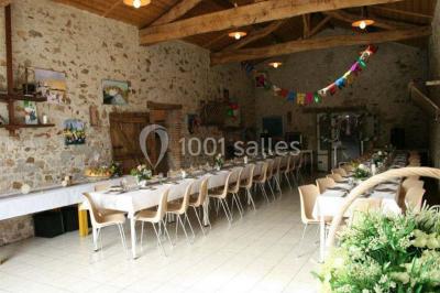 Allée asphaltée éclairée par des lampes extérieures, bordée de plantes et menant à une maison dans l'obscurité.