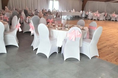 Bar avec éclairage rouge, comptoir en bois, étagères avec verres et décorations, ambiance tamisée.