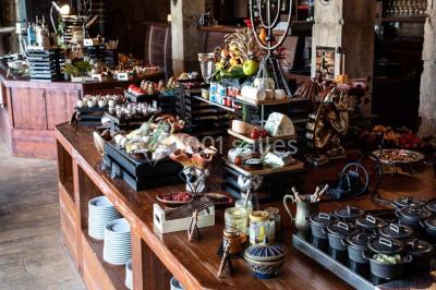 Vue nocturne d'un complexe de loisirs avec piscine illuminée, bâtiments thématiques et paysage urbain en arrière-plan.
