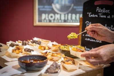 Un barman réalise un spectacle de flair bartending avec des verres et un shaker dans une salle éclairée.