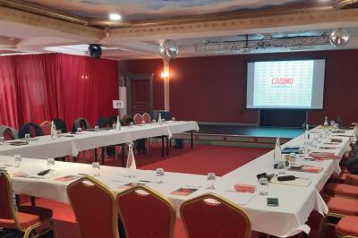 Un barman réalise un spectacle de flair bartending avec des verres et un shaker dans une salle éclairée.
