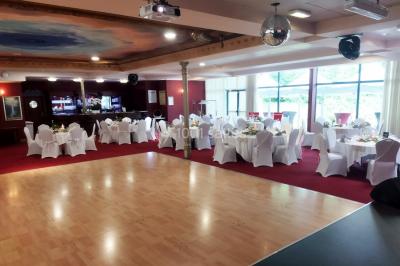 Un barman réalise un spectacle de flair bartending avec des verres et un shaker dans une salle éclairée.