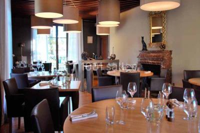 Assiette gastronomique avec légumes colorés, asperges, sauce crémeuse, tranche de viande et fleur comestible en décoration.