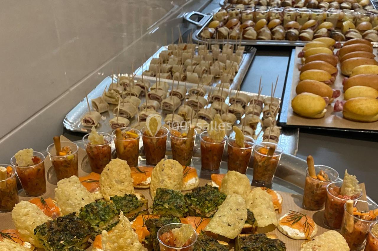 Plateaux de bouchées apéritives variées comprenant verrines, roulés, mini-sandwichs et pommes de terre farcies.