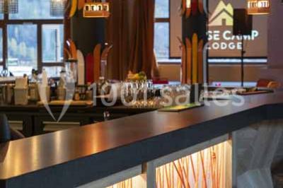 Assiette de repas avec légumes colorés, gratin, pain et verres de vin rouge sur une table en bois.