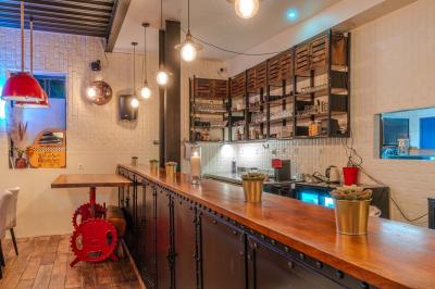 Salle intérieure avec terrain de sport entouré de filets, tables et chaises disposées sur un sol en gazon synthétique.