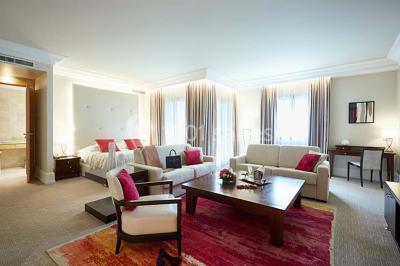 Un public assis dans une salle de conférence, attentif à une présentation sur une scène éclairée.