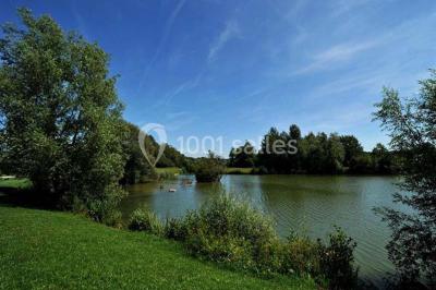 Tables dressées avec des ustensiles de cuisine, planches vertes et ingrédients, dans une salle lumineuse.
