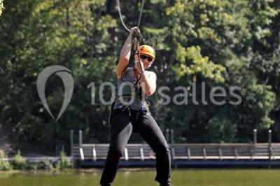 Tables dressées avec des ustensiles de cuisine, planches vertes et ingrédients, dans une salle lumineuse.