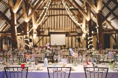 Platines vinyles et disques exposés sur une table en extérieur, avec un jardin verdoyant et un pigeonnier à colombages en…