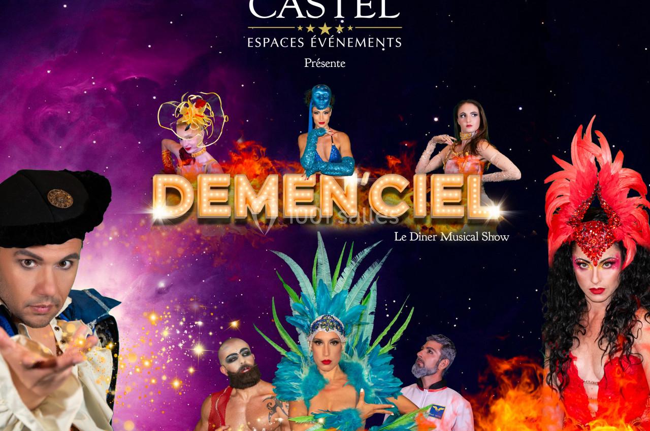 Des artistes en costumes colorés posent devant un fond cosmique avec le titre ’Demenciel’ en lettres lumineuses.