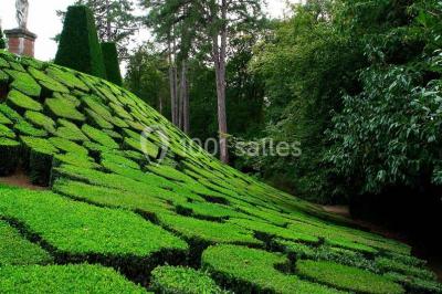 Salle de bain avec cabine de douche arrondie en verre, lavabo intégré dans un meuble en bois et carrelage beige.