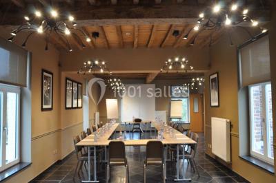 Plafond en bois apparent dans une pièce décorée avec un sapin de Noël blanc, un miroir et des meubles anciens.