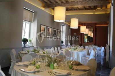 Plafond en bois apparent dans une pièce décorée avec un sapin de Noël blanc, un miroir et des meubles anciens.
