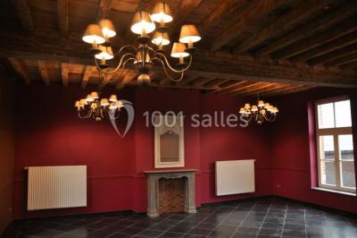 Plafond en bois apparent dans une pièce décorée avec un sapin de Noël blanc, un miroir et des meubles anciens.