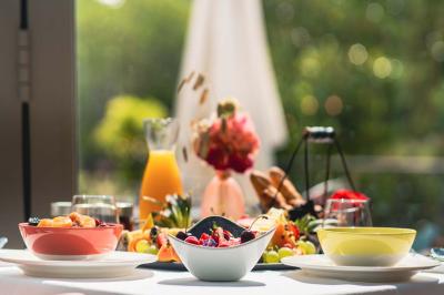 Une femme reçoit un massage sur une table dans une pièce chaleureuse avec des rideaux, des bougies et une lumière tamisée.