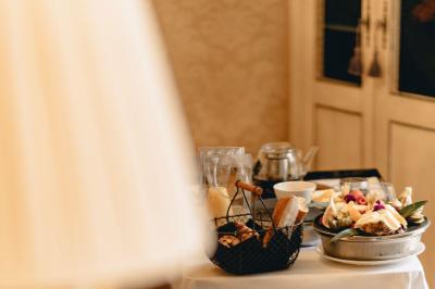 Une femme reçoit un massage sur une table dans une pièce chaleureuse avec des rideaux, des bougies et une lumière tamisée.