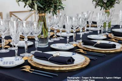 Miniature Options Orléans #18 Salle lumineuse avec parquet en bois, table ronde dressée avec nappe rouge, et moulures décoratives au plafond.