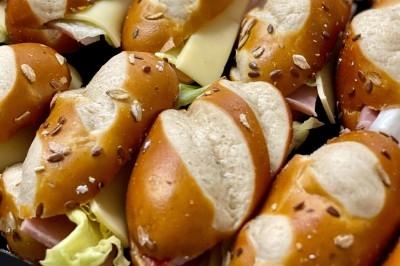 Portion de viande braisée servie dans une petite coupelle, garnie de pousses rouges.