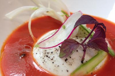 Tarte garnie de fruits frais variés, crème chantilly et feuilles de menthe, servie sur une assiette blanche.