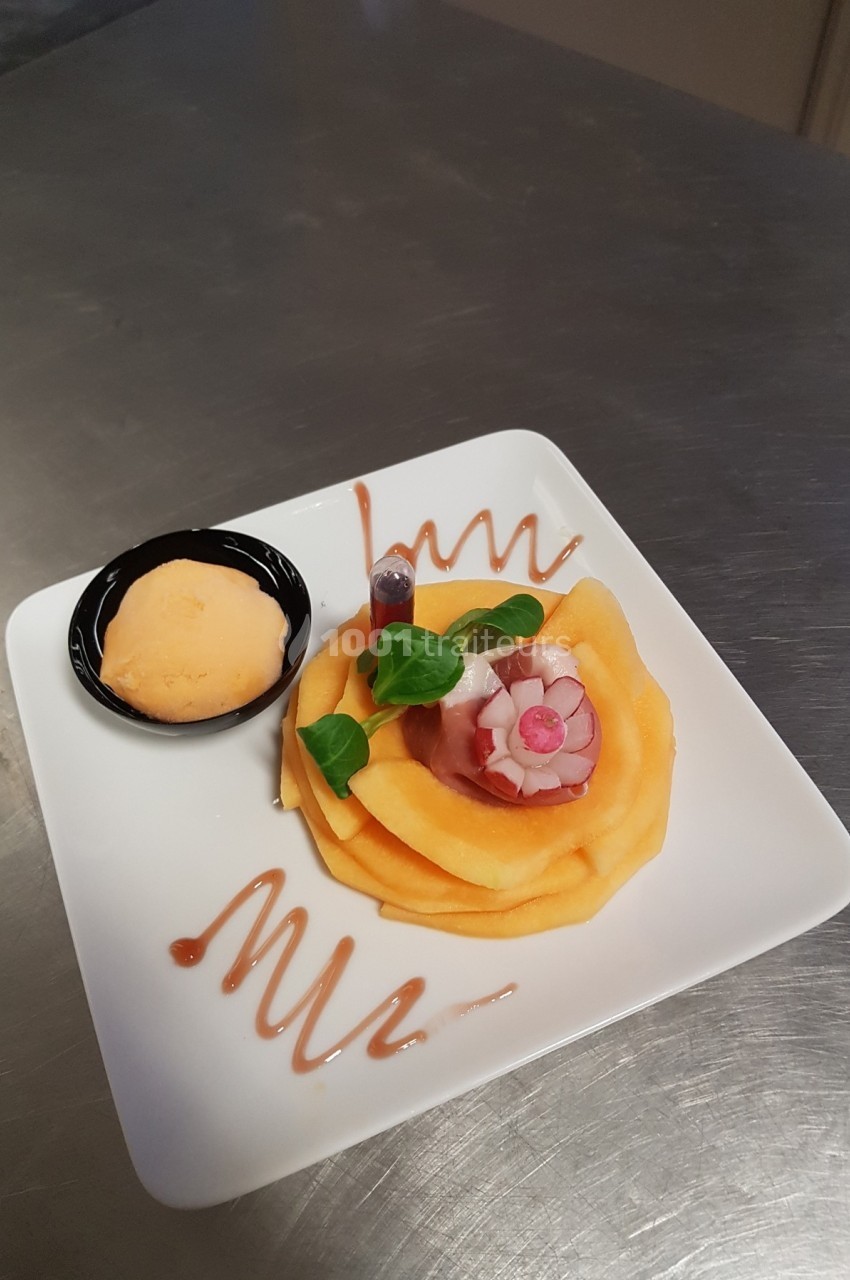 Assiette de carpaccio de melon avec décoration florale, accompagné d'une boule de sorbet et d'un filet de sauce.