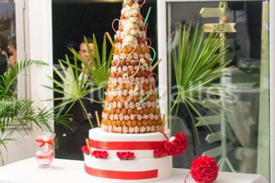 Dessert raffiné composé d'une mousse rose, d'une sauce rouge en verrine et d'un carré de chocolat décoratif.