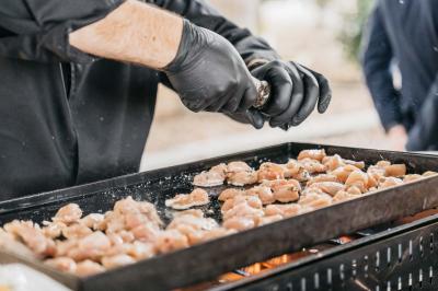 Dessert raffiné composé d'une mousse rose, d'une sauce rouge en verrine et d'un carré de chocolat décoratif.