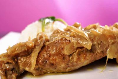 Plateau de verrines colorées garnies de fruits frais comme kiwi, fraise et mangue, tenu par une personne.