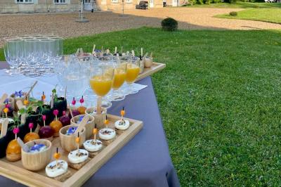Plateau de bouchées apéritives variées avec charcuterie, légumes, verrines et décorations colorées.