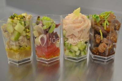 Rouleau de saumon, mangue et concombre présenté sur une petite assiette en bois.