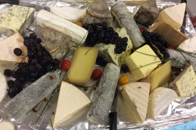 Chambre mansardée avec deux lits simples, parquet clair, poutres apparentes et lumière naturelle provenant d'un velux.