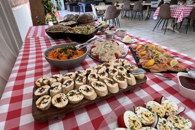Plateau à étages avec des coquilles garnies de crevettes, légumes et herbes, présenté sur une table de buffet.