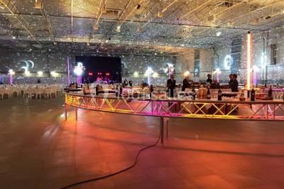 Plateau de mini-burgers colorés et assortiments de canapés sur une table dressée pour un buffet.