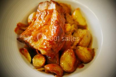 Bol de farine, fouet métallique, citrons, zesteur, beurre et noisettes posés sur une planche en bois.